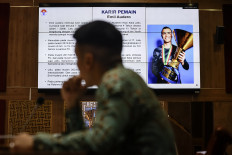 A member of House of Representatives Commission X overseeing youth and sports affairs look at the screen on March 5, 2025, during a meeting with Deputy Youth and Sports Minister Taufik Hidayat and Soccer Association of Indonesia (PSSI) chair Erick Thohir at the Senayan legislative complex in Jakarta. The meeting was about the grant of Indonesian citizenship to three foreign soccer players so they can join the country's senior men's soccer team.