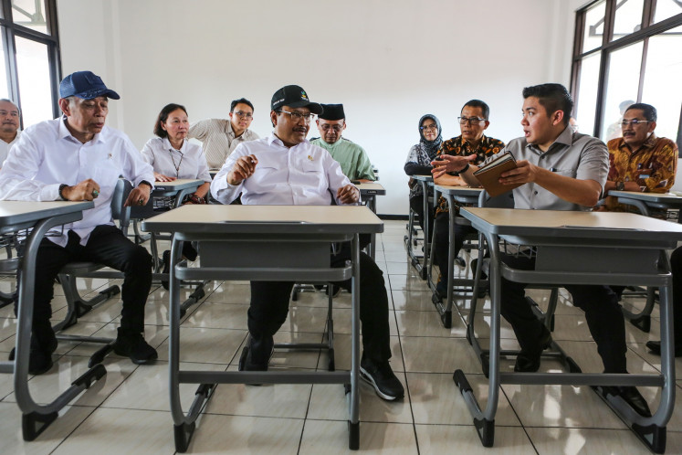Social Affairs Minister Saifullah Yusuf (center) and his deputy Agus Jabo Priyono (left) listen to Cabinet Secretary Teddy Indra Wijaya on March 8, 2025, during an inspection visit at a designated site for the Sekolah Rakyat (community school) initiative in Bekasi, West Java.