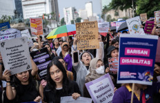 Participants march during a protest organized by the Indonesian Women's Alliance (API) on the 50th International Women's Day demanding labor rights, gender equality and protections, on March 8, 2025, in Jakarta.