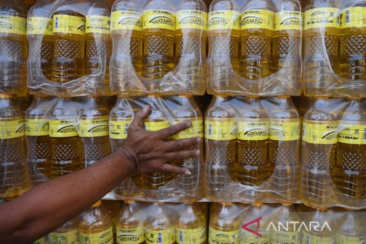 A port office at North Jakarta's Tanjung Priok Port prepares to deliver crates full of bottled Minyakita cooking oil to eastern Indonesia on March 3. The National Police launched a probe on March 9 into three producers of the state-subsidized cooking oil following reports that quantities being sold on retail shelves fell short of the amount mandated by policy.