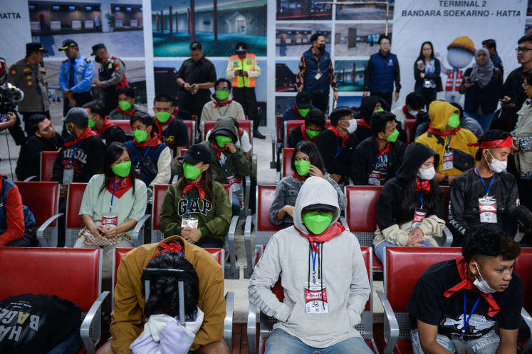 Indonesian migrant workers repatriated from Myanmar wait for an airport transfer upon their arrival at Soekarno-Hatta International Airport in Tangerang, Banten, on Feb. 28, 2025. Eighty-four Indonesian migrant workers were repatriated from Myanmar through Thailand after they were found working in illegal cyber scam centers.