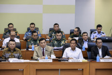Defense Minister Sjafri Sjamsoeddin (second left) sits with Law Minister Supratman Andi Agtar (right), Deputy Defense Minister Donny Ermawan Taufanto (second right) and First Deputy State Secretary Bambang Eko Suharyanto (left) on March 11, 2025, during a working meeting with House of Representatives Commission I overseeing military affairs at the Senayan legislative complex in Jakarta. During the meeting, the government representatives discuss about the revision of the 2004 Indonesian Military (TNI) Law.