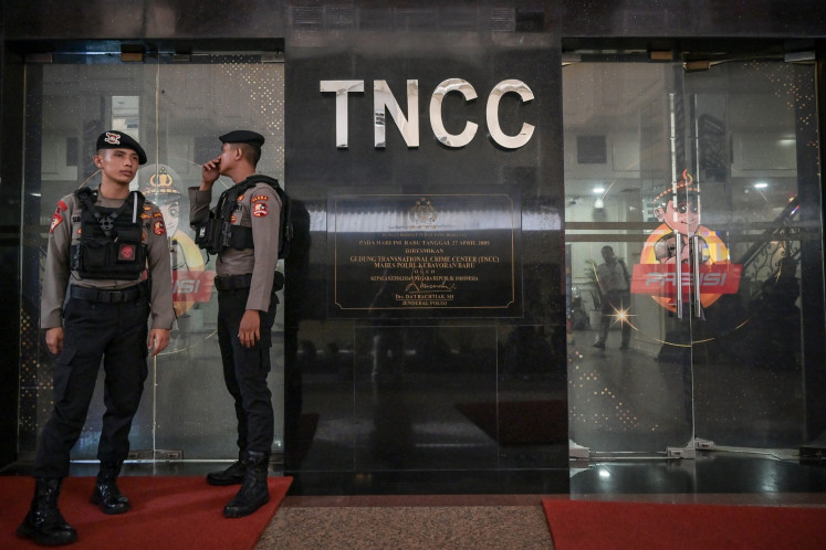 Police officers stand guard at the National Police's Internal Affairs Division's Transnational Crime Center (TNCC) building in Jakarta on March 17, 2025 during an ethical hearing against former Ngada Police chief Adj. Sr. Comr. Fajar Widyadharma Lukman Sumaatmaja. The National Police ethics commission (KKEP) dishonorably discharged Fajar after finding him guilty of ethical violations for molesting children as well as recording and spreading the footage on the internet and misusing drugs.