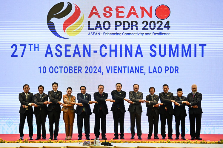 Myanmar's Permanent Secretary of Foreign Affairs Aung Kyaw Moe (from left), Philippine President Ferdinand Marcos Jr, Singaporean Prime Minister Lawrence Wong, Thailand's Prime Minister Paetongtarn Shinawatra, Vietnam's Prime Minister Pham Minh Chinh, China's Premier Li Qiang, Laos' Prime Minister Sonexay Siphandone, Malaysia's Prime Minister Anwar Ibrahim, Brunei's Sultan Hassanal Bolkiah, Cambodia's Prime Minister Hun Manet, Vice President Ma'ruf Amin and Timor-Leste's Prime Minister Xanana Gusmao pose for a group photo at the 27th ASEAN-China Summit during the 44th and 45th ASEAN Summits in Vientiane on Oct. 10, 2024.