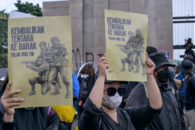 Students show placards reading “Return the soldiers to the barracks“ on March 20, 2025, during a protest against a revision of the Indonesian Military (TNI) Law in front of the Senayan legislative complex in Jakarta. The House of Representatives passed the TNI Law revision at a plenary session on March 20 despite opposition and concerns from the public that the new law would expand the military's role in the country's civilian affairs.