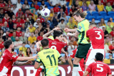 Australia's Jackson Irvine (center) heads the ball to score a goal during the 2026 FIFA World Cup Asian qualification football match between Indonesia and Australia at Allianz Stadium in Sydney on March 20, 2025. 