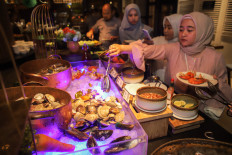 Celebration: Visitors take iftar dishes prepared at the DoubleTree by Hilton Surabaya in East Java on March 6, 2025.