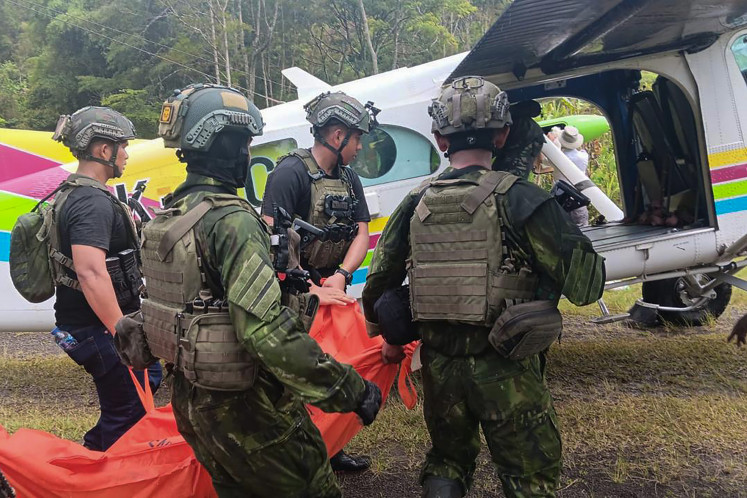 The Indonesian Military (TNI) members evacuate the body of a victim following an attack by the Free Papua Movement (OPM) rebel group in Anggruk Districk, Yahukimo Regency, Papua Highlands, on March 23, 2025.