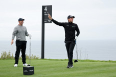 Rory McIlroy (left) of Northern Ireland and Viktor Hovland of Norway react to Hovland's shot from the fourth tee during the first round of The Genesis Invitational 2025 at Torrey Pines Golf Course on Feb. 13, 2025, in La Jolla, California, the United States.