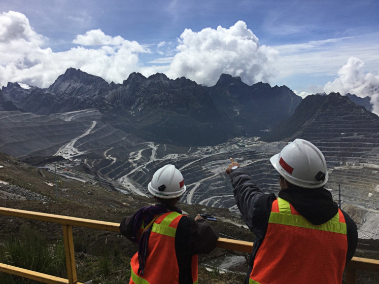 Workers at a mining site of PT Freeport Indonesia look at the Carstensz Pyramid in this undated photograph.