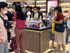Shoppers visit the stall of a local perfume brand on March 22, 2025, during a beauty bazaar at a mall in South Jakarta.