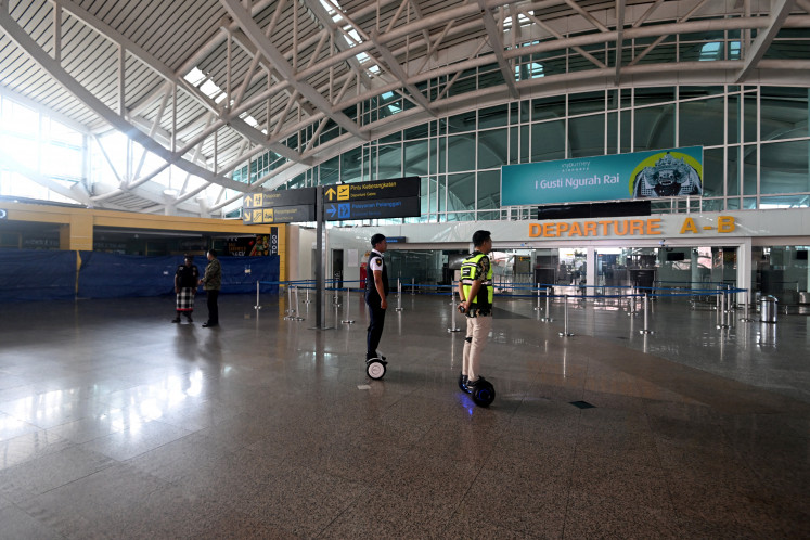Local security guards and airport security officers patrol inside the International Ngurah Rai airport during Nyepi Day in Tuban, on Indonesia's resort island of Bali on March 29, 2025. Hindus on the island of Bali observe Nyepi by refraining from going to work, travel or taking part in any indulgence. Bali shuts down for the day of silence to mark the Hindu new year on March 29.