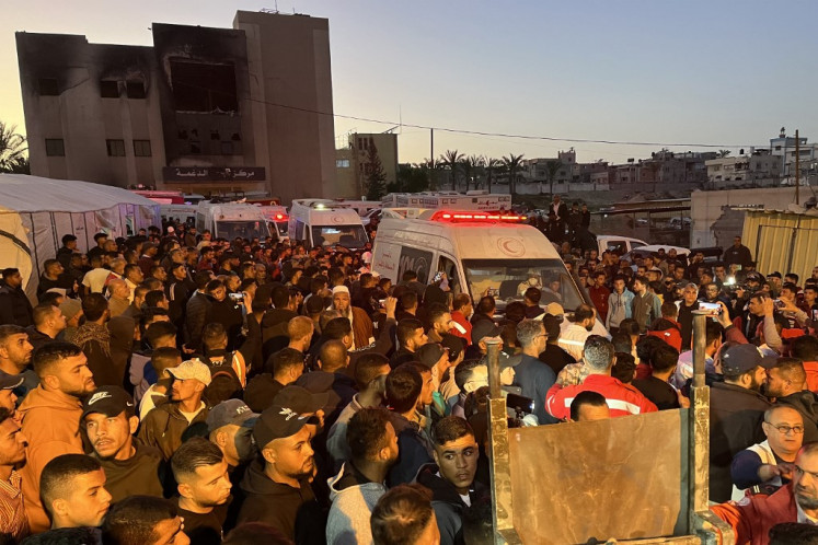 Ambulances carrying the bodies of Palestinian first responders who were killed a week before in Israeli military fire on other ambulance vehicles arrive at Nasser Medical Complex in Khan Yunis in the southern Gaza Strip on March 30, 2025. The Palestinian Red Crescent said on March 30 that it had recovered the bodies of 15 rescuers from the Red Crescent, Gaza's civil defence agency, and one UN agency employee. The group said the those killed “were targeted by the Israeli occupation forces while performing their humanitarian duties as they were heading to the Hashashin area of Rafah to provide first aid to a number of people injured by Israeli shelling in the area“.
