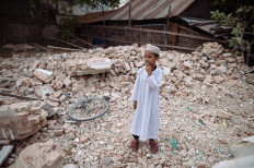 A muslim boy stands on the rubble of a collapsed building in Mandalay on March 31, 2025, three days after the deadly Myanmar earthquake. Hopes were fading of finding more survivors in the rubble of Mandalay, where some residents spent a third night sleeping in the open after a massive earthquake killed at least 1,700 people in Myanmar and neighbouring Thailand.
