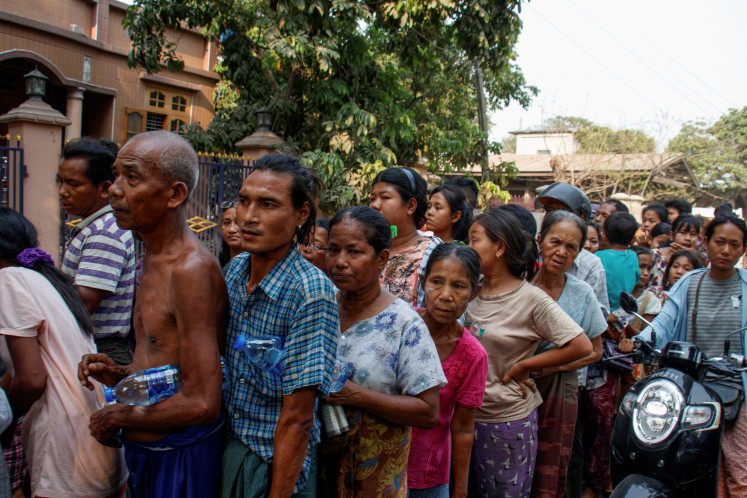 People queue for relief supplies after a strong earthquake near the earthquake's epicenter, in Sagaing, Myanmar, March 31, 2025. 