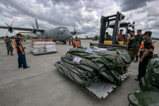 Indonesian Air Force troops and National Disaster Mitigation Agency officials prepare to load humanitarian aid from the Indonesian government for earthquake victims in Myanmar into a Hercules C-130 transport aircraft on March 31, 2025, at Halim Perdanakusuma Air Base in Jakarta.
