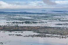 This handout photo taken on March 29, 2025 and released by The Queensland Fire Department shows homes under floodwaters in the town of Jundah in south-west Queensland. 