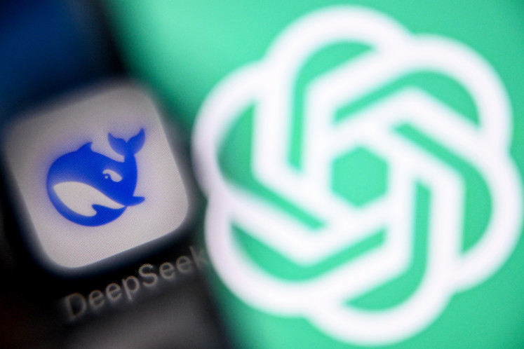 A photo taken on April 1, 2025 shows the GPT chat logo on a laptop screen (right) next to the logo of Deepseek AI application on a smartphone screen in Frankfurt am Main, western Germany.