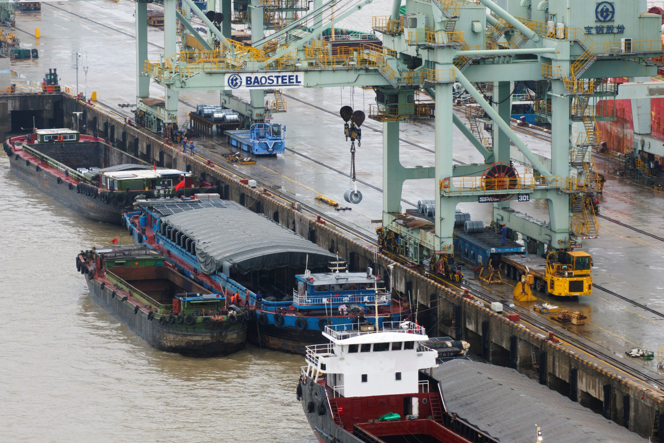 A crane transports steel coil at a port under Baosteel Group, in Baoshan district of Shanghai, China, on March 13, 2025.
