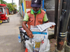 Paper man: Kadum sells newspapers and magazines from his bicycle. 