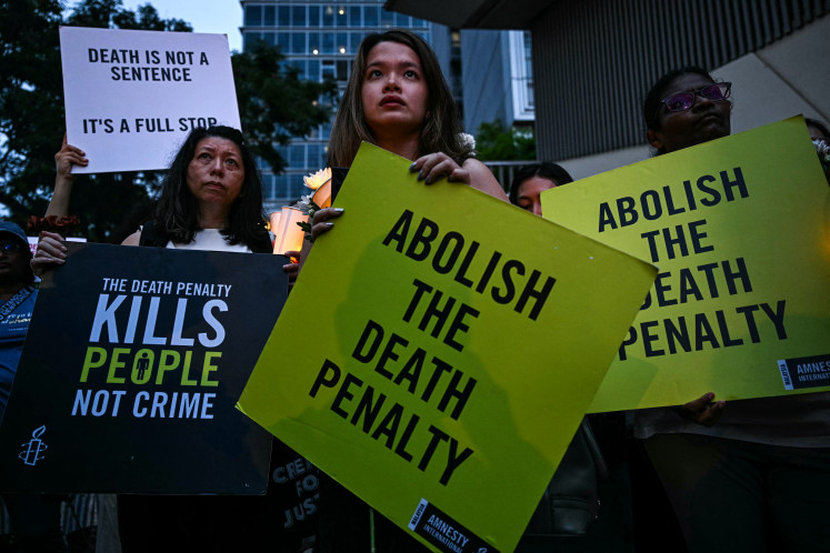 Activists hold placards during a vigil on Feb. 19, 2025 against the impending execution of Malaysian national Pannir Selvam Pranthaman, sentenced to death for trafficking heroin into Singapore, outside the Singaporean embassy in Kuala Lumpur.