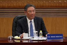 Chinese Commerce Minister Wang Wentao attends a meeting with global business leaders at the Great Hall of the People in Beijing on March 28, 2025.