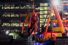 Emergency personnel work at the scene of a helicopter crash on the Hudson River near lower Manhattan in New York, as seen from Newport, New Jersey US, April 10, 2025. 
