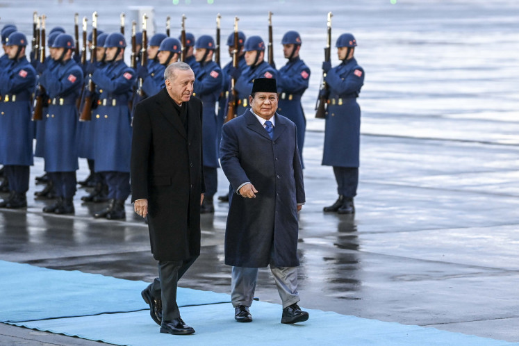 President Prabowo Subianto (right) talks to Turkish President Recep Tayyip Erdogan as he arrives at Esenboga International Airport in Ankara on April 9, 2025.