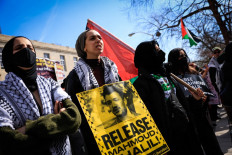 People hold signs as they participate in a protest in support of Columbia University student activist Mahmoud Khalil while a hearing takes place outside the court in Newark, New Jersey on March 28, 2025. An immigration judge ruled on April 11, 2025 that pro-Palestinian student protester Mahmoud Khalil, a United States permanent resident detained by the Trump administration, can be deported, US media and a legal rights group said.