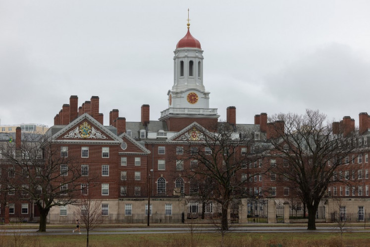  A person runs past Dunster House at Harvard University on March 17, 2025 in Cambridge, Massachusetts.