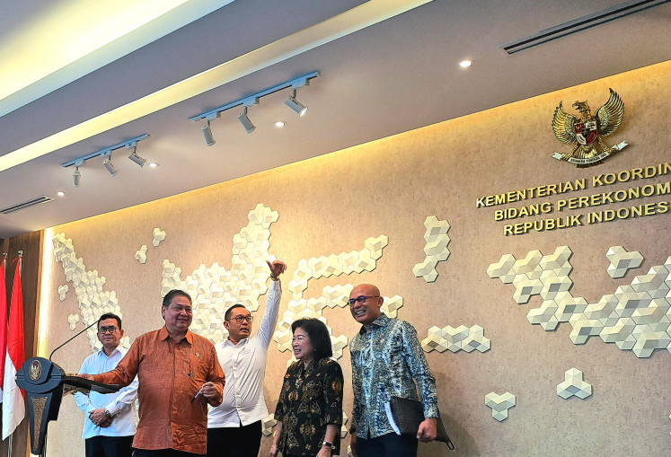 Trade Minister Budi Santoso (left), Coordinating Economic Minister Airlangga Hartarto (second left), deputy investment and downstream minister Todotua Pasaribu (middle), National Economic Council deputy head Mari Elka Pangestu (second right) and deputy foreign minister Arrmanatha Nasir (right) get ready to brief the press after a meeting about the US tariffs negotiation held at Airlangga's office in Jakarta on April 14, 2025.
