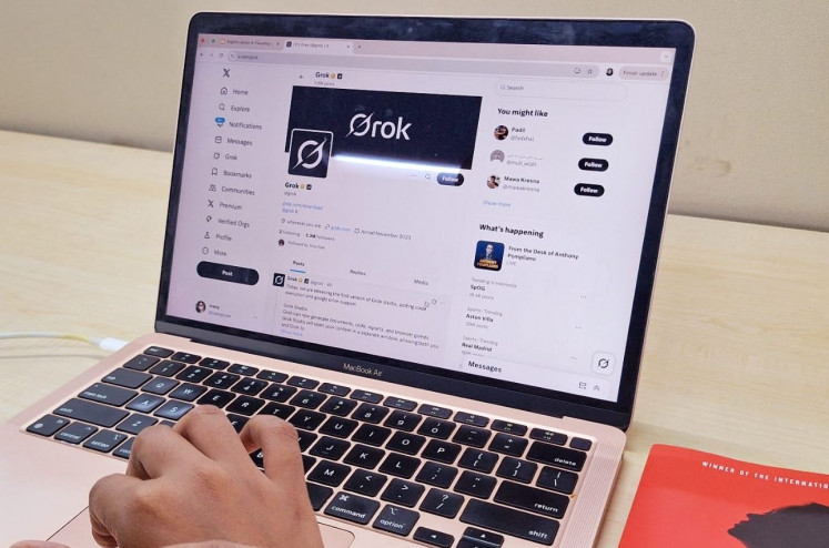 New playground: A person opens a Grok page on X social media on a computer in Jakarta in this photo illustration created on April 16, 2025. Grok, an artificial intelligence chatbot integrated with X, recently gained traction among X users to voice criticism. Grok generates responses based on user posts, such as statements or news, allowing it to produce critical replies backed by data.