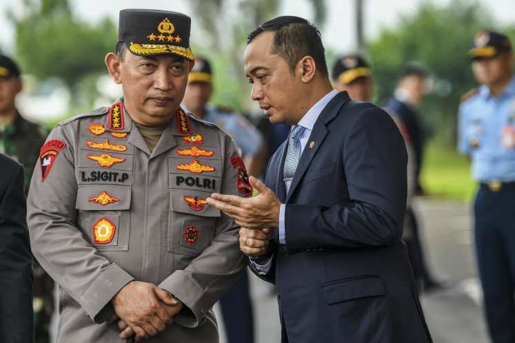 Strengthening communication: State Secretary Prasetyo Hadi (right) talks with National Police chief Gen. Listyo Sigit Prabowo (left) on Tuesday while waiting for President Prabowo Subianto to arrive at the Halim Perdanakusuma Air Force Base in Jakarta from his visit to the Middle East.