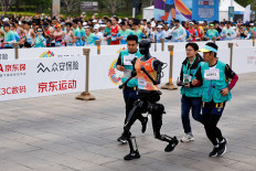 Humanoid robot “Tiangong“ participates along with human runners in the E-Town Half Marathon & Humanoid Robot Half Marathon in Beijing, China on April 19, 2025.