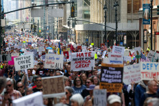 People march during the “Protect Migrants, Protect the Planet” rally in New York City, US, April 19, 2025. 