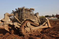 An unmanned D9 bulldozer digs up a field during a demonstration to the press at the Israel Aerospace Industries (IAI) quarters near Tel Aviv on March 26, 2025.