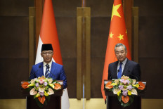 Foreign Minister Sugiono (left) and China's Foreign Minister Wang Yi attend a press briefing after the first meeting of the China-Indonesia joint foreign and defence ministerial dialogue at the Diaoyutai State Guest House in Beijing on April 21, 2025. 