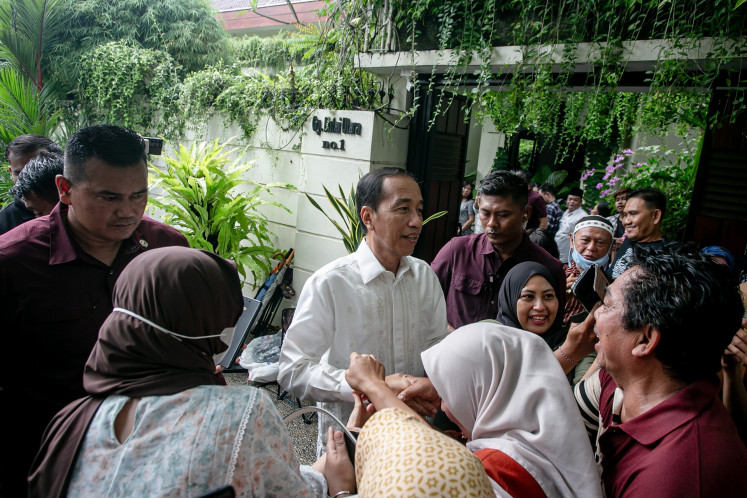 Former president Joko “Jokowi“ Widodo greets people lining up in front of his house in Surakarta, Central Java for a get-together event with the former president on April 2, 2025.