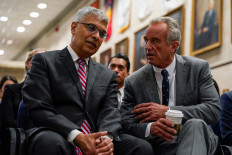US Health and Human Services (HHS) Secretary Robert F. Kennedy, Jr. speaks with Director of the National Institutes of Health Jay Bhattacharya ahead of a press conference announcing the US Food and Drug Administration's (FDA) intent to phase out the use of petroleum-based synthetic dyes in the nation's food supply, at the Department of Health and Human Services in Washington, DC, on April 22, 2025.