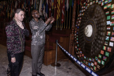 Two diplomatic delegates inspect the gong that was used to officiate the 50th anniversary of the 1955 Asia-Africa Conference,on April 23 at the Merdeka Building in Bandung, West Java. More than a dozen foreign dignitaries visited the Asia-Africa Museum as part of an event to commemorate the 70th anniversary of the conference in 2025.