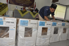 A district election committee (PPK) opens ballot boxes during a vote tabulation of the Tasikmalaya regency regional election revote in West Java on April 21, 2025. The regency was one of 24 regions ordered by the Constitutional Court in February to hold reruns of the 2024 regional elections.