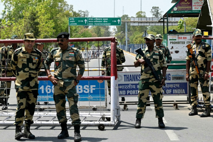 Indian Border Security Force (BSF) soldiers stand guard at the India-Pakistan Wagah border post on the outskirts of Amritsar on April 24, 2025. 