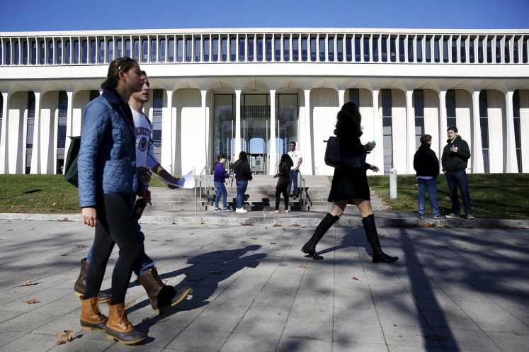 People walk past Princeton University's Woodrow Wilson School of Public and International Affairs in Princeton, New Jersey, the United States on Nov. 20, 2015.