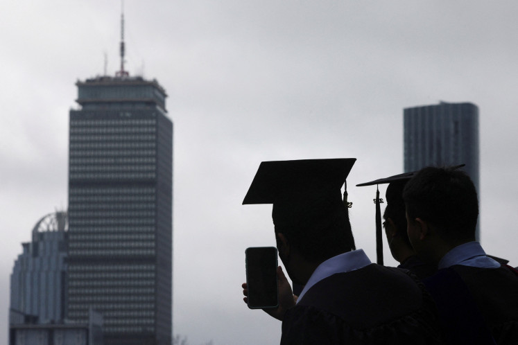 A graduating student records the academic procession during the commencement ceremony at the Massachusetts Institute of Technology (MIT) in Cambridge, Massachusetts, the United States on May 27, 2022.