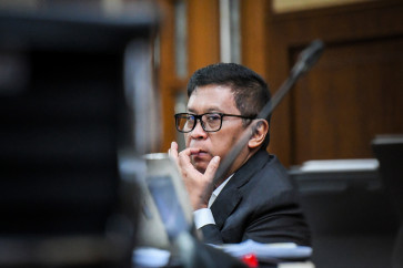 Indonesian Democratic Party of Struggle (PDI-P) secretary-general Hasto Kristiyanto listens to the witness testimony during a hearing at the Jakarta Corruption Court on April 24. Hasto is standing trial for bribery and obstruction of justice in a case that involves former General Elections Commission (KPU) member Wahyu Setiawan.