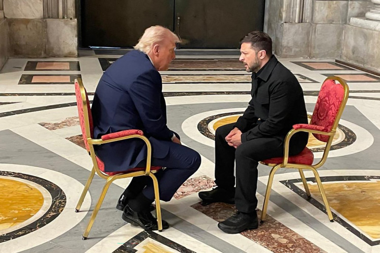 In this handout photograph taken and released by the Ukrainian Foreign Ministry on April 26, 2025, Ukraine's President Volodymyr Zelensky (right) meets with US President Donald Trump (left) on the sidelines of Pope Francis's funeral at St. Peter's Basilica at The Vatican.  The US and Ukraine on April 30, 2025 signed a minerals deal after a two-month delay, in what President Trump's administration called a new form of US commitment to Kyiv after the end of military aid. Ukraine said it secured key interests after protracted negotiations, including full sovereignty over its own rare earths, which are vital for new technologies and largely untapped.