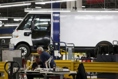 Employees work on the line at automaker General Motors (GM) Brightdrop unit's CAMI EV Assembly, Canada's first full-scale electric vehicle manufacturing plant, in Ingersoll, Ontario, Canada, on Dec. 5, 2022.
