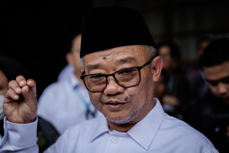 Elementary and Secondary Education Minister Abdul Mu'ti gestures as he talks to reporters on March 13, 2025, after launching a new system for transferring allowances directly to public school teachers at the ministry in Senayan, Central Jakarta.