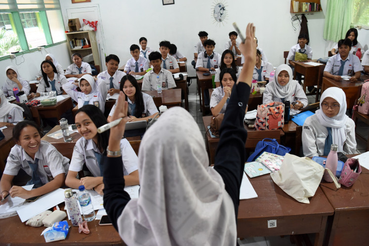Students react to their teacher on April 14, 2025, at SMAN 70 Jakarta state senior high school in Kebayoran Baru, South Jakarta.
