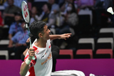 Indonesia's Alwi Farhan hits a return to Denmark's Anders Antonsen during their mens singles match at the Sudirman Cup badminton championship in Xiamen, Chinas southeastern province on May 1, 2025. 